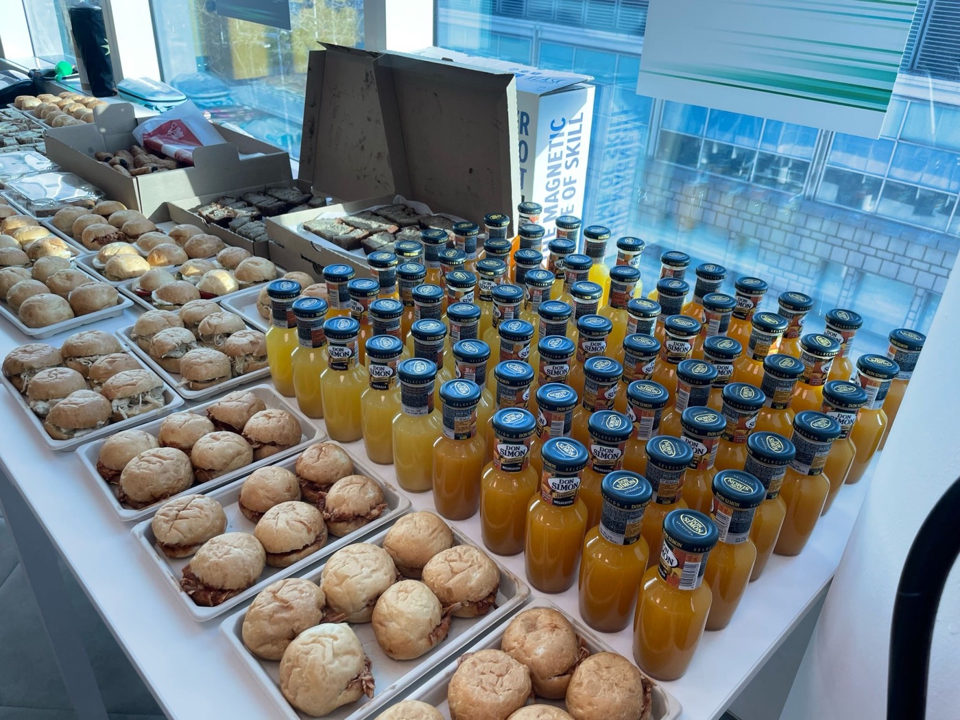 Corporate breakfast catering in a Barcelona office: mini sandwiches, juices and banana bread